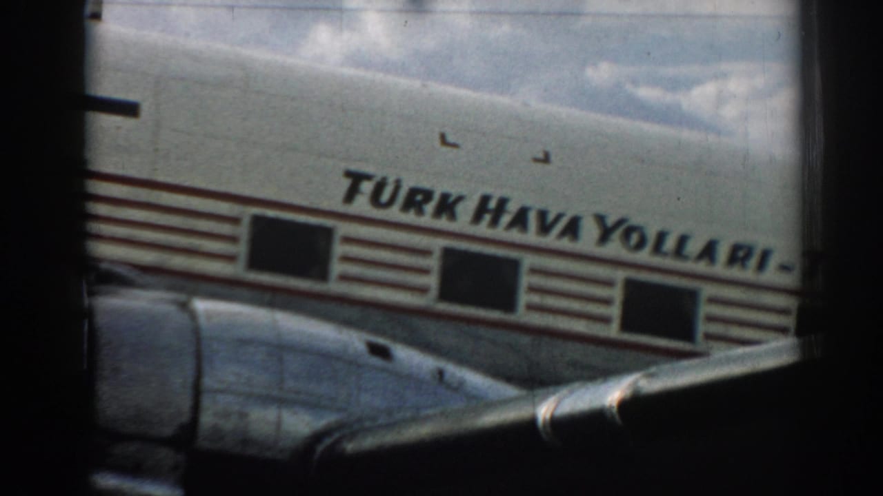 The Turk Hava Yollari name is visible on the aircraft fuselage, with part of the wing and cloudy sky in view.