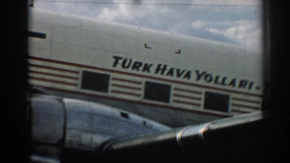 The Turk Hava Yollari name is visible on the aircraft fuselage, with part of the wing and cloudy sky in view.