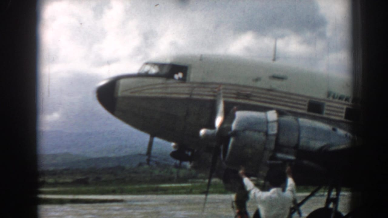Turkish Airlines propeller aircraft on a cloudy airfield with a ground crew member below.