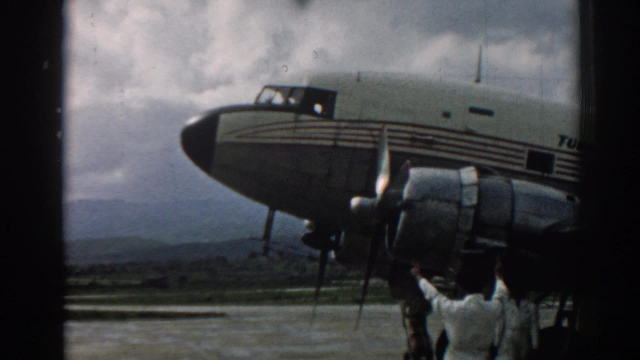 End frame from the 1962 Izmir clip showing the Turk Hava Yolları aircraft, radial engine, fuselage stripes, tarmac, and crew member.