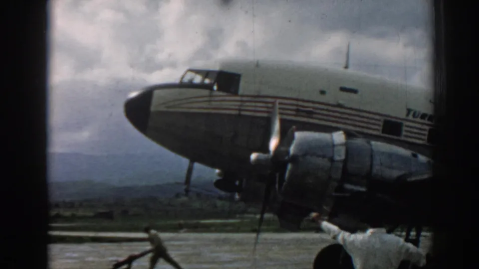 1962 Izmir airport footage showing a Turkish Airlines propeller aircraft nose and engine with ground crew working nearby.