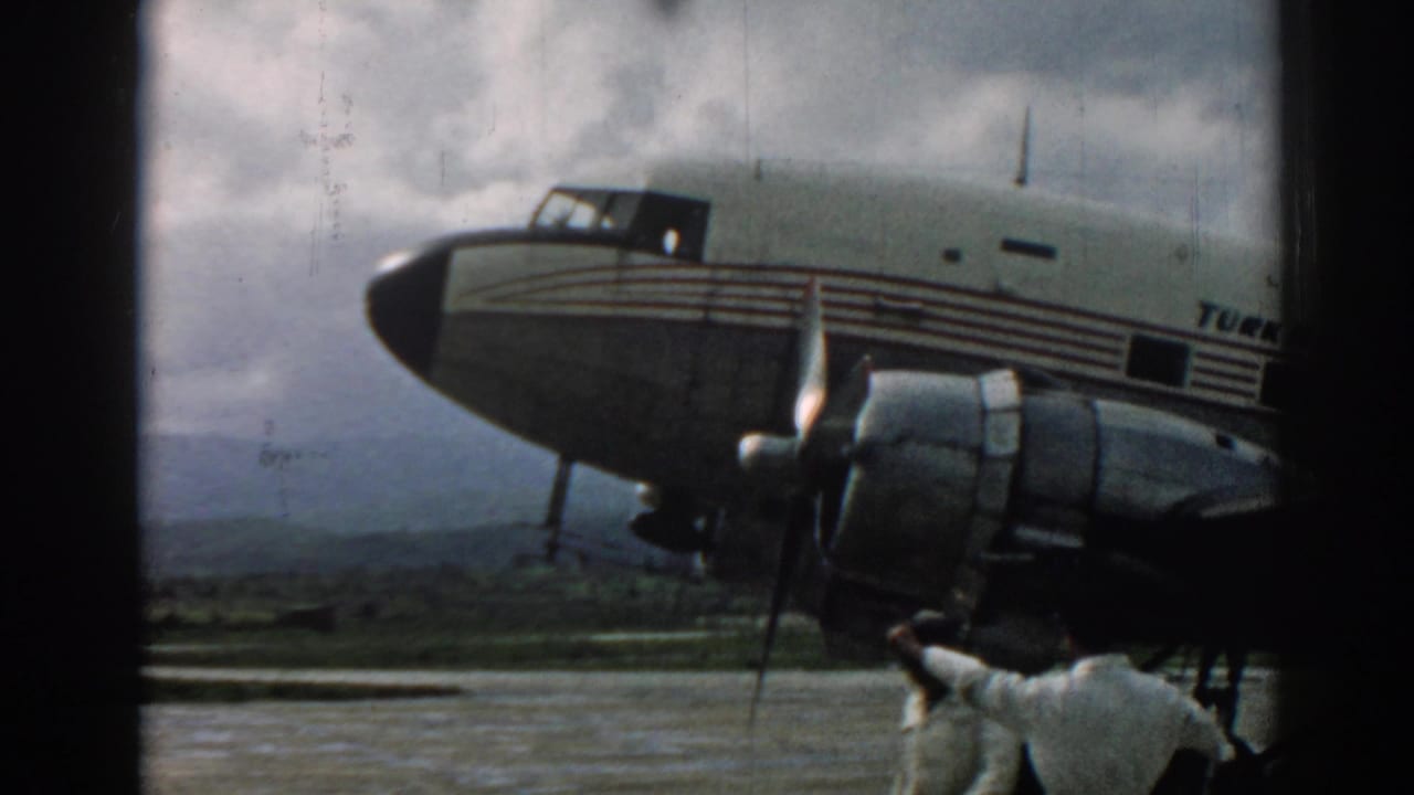 1962 Izmir airport view of a Turkish Airlines aircraft as a ground crew member gestures near the propeller engine.