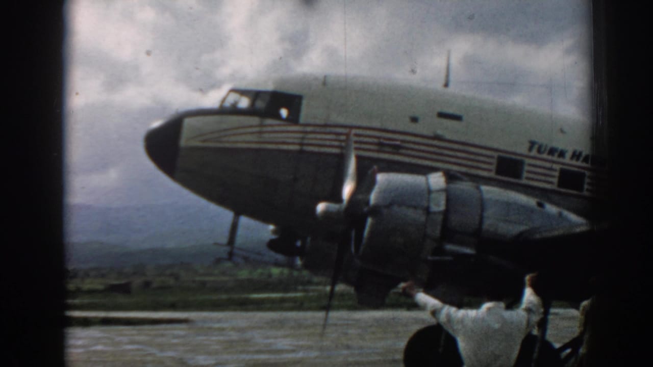 A 1962 home-movie frame from Izmir shows the aircraft side, engine, and partial Turkish Airlines name on an airport tarmac.