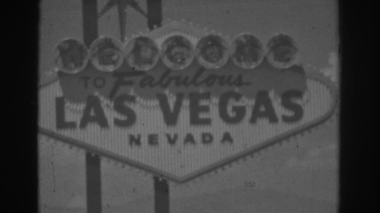 1962 Las Vegas home-movie frame showing the Welcome to Fabulous Las Vegas Nevada sign in soft black-and-white daylight.