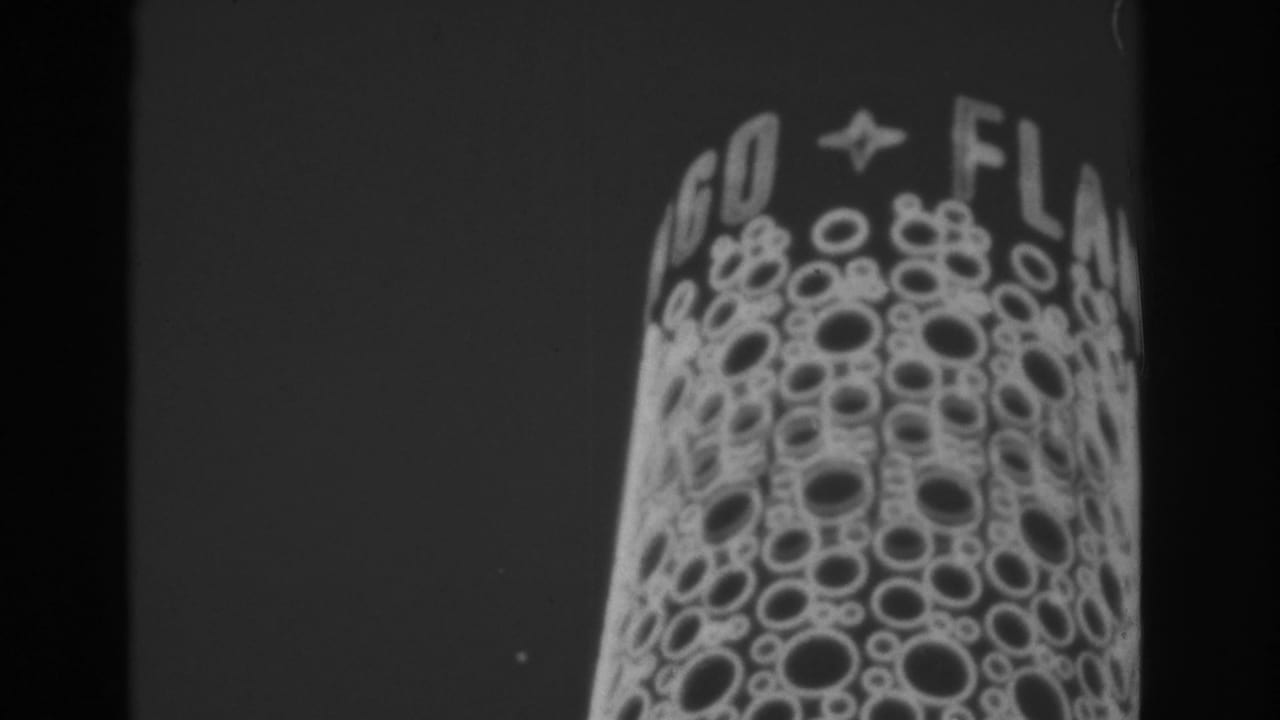 1962 Las Vegas frame showing a close-up of a lighted sign face with circular bulb patterns and partial lettering above it.