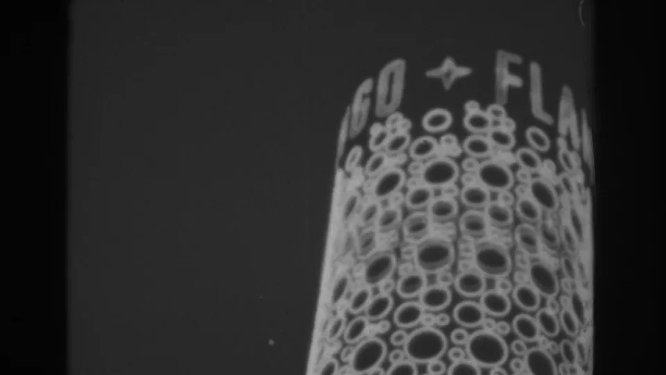 1962 Las Vegas frame showing a close-up of a lighted sign face with circular bulb patterns and partial lettering above it.