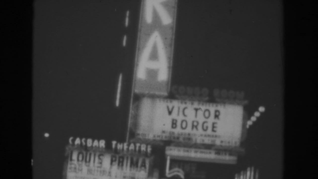 Nighttime theater signs and marquees with Victor Borge and Louis Prima billings.