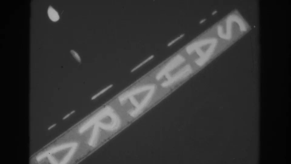 A steady 1962 Las Vegas view of the illuminated Sahara sign, cropped tightly against the evening sky.