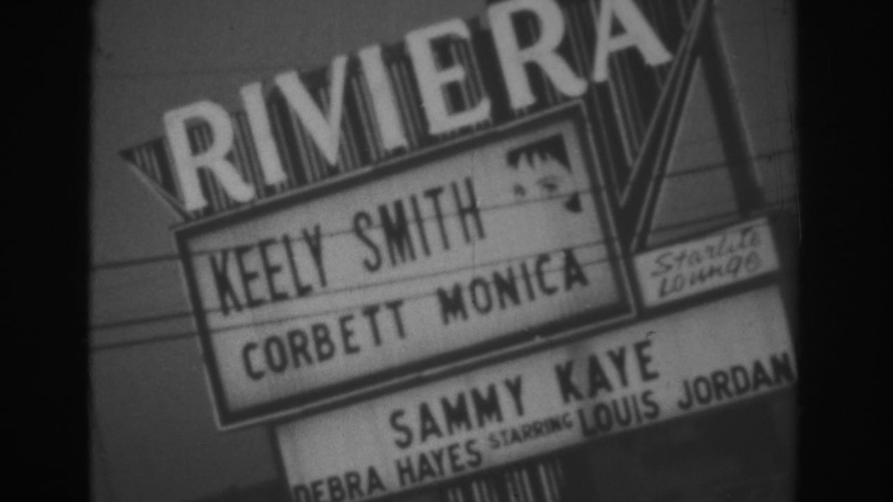 Handheld 8mm view of the Riviera marquee in Las Vegas with visible performer billing and sign supports.