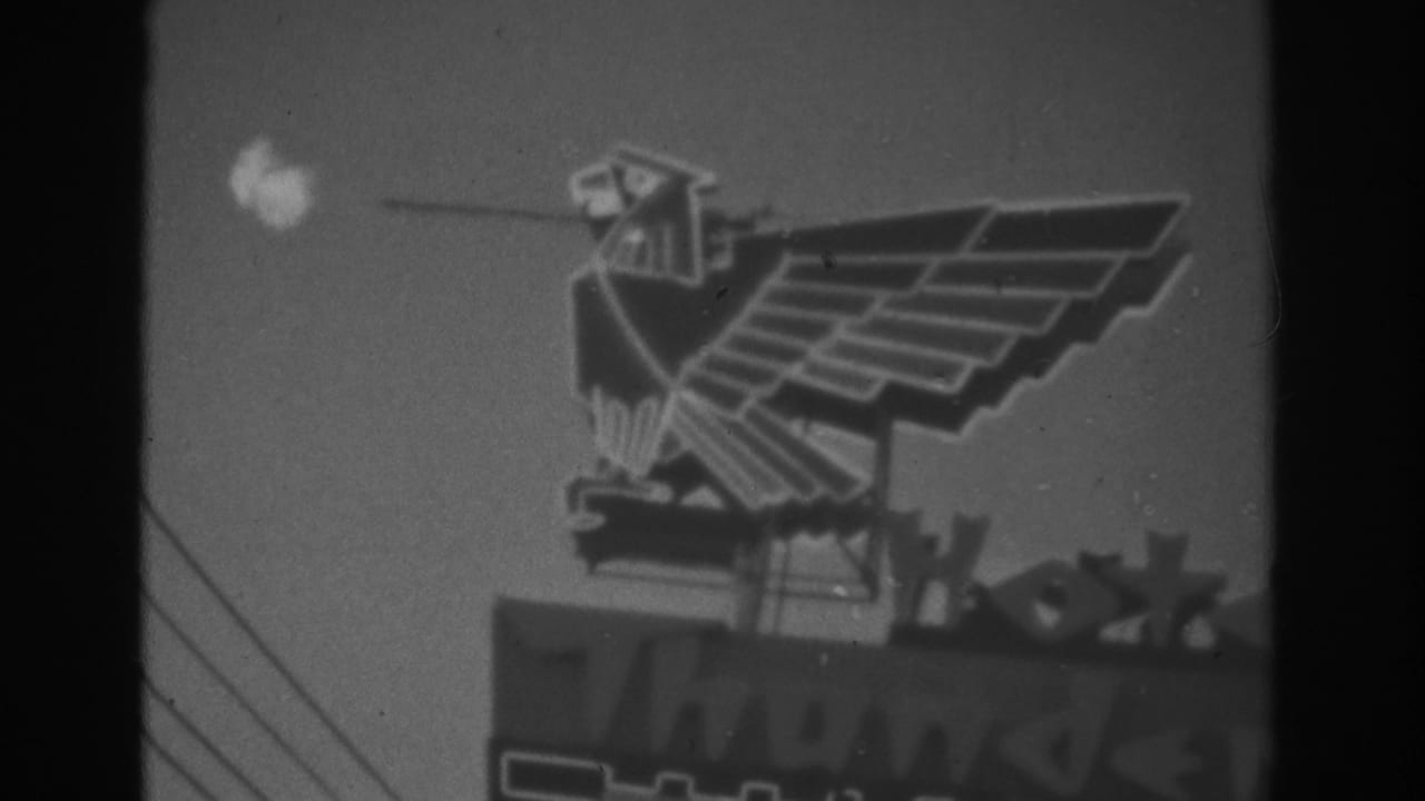 1962 Las Vegas 8mm frame showing a geometric eagle sign appearing to spit fire above partly visible illuminated lettering.
