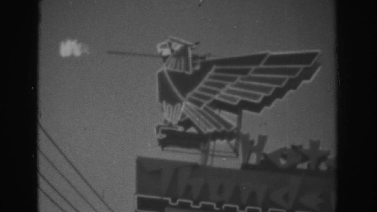 1962 Las Vegas frame of a geometric eagle sign at night, with a bright plume near the beak and partial signage below.