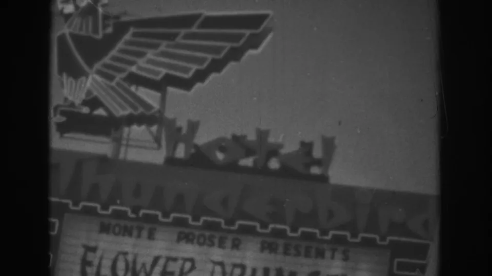 1962 Las Vegas frame with the Thunderbird eagle emblem and marquee text softened by 8mm focus and grain.