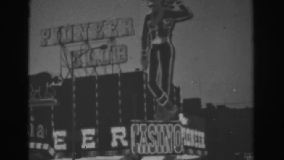Black-and-white 1962 Las Vegas view of the Pioneer Club casino sign with visible neon-style lettering and cowboy figure.