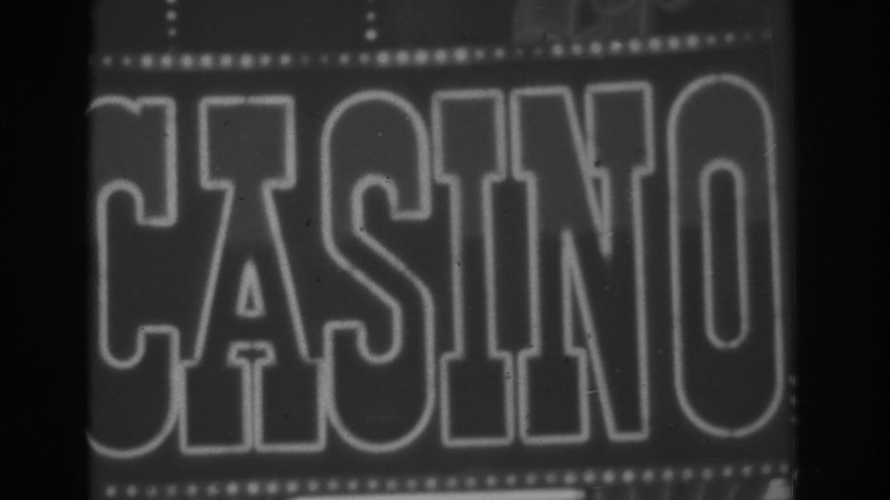 Cropped 1962 Las Vegas casino sign view, with large outlined letters and visible small-gauge film grain and softness.