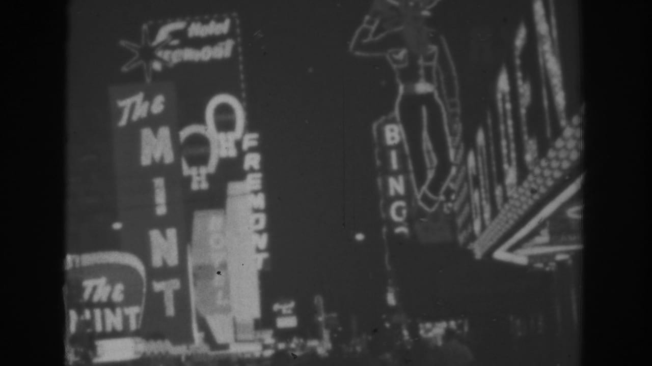 Black-and-white neon signs for The Mint, Hotel Fremont, and Bingo at night.