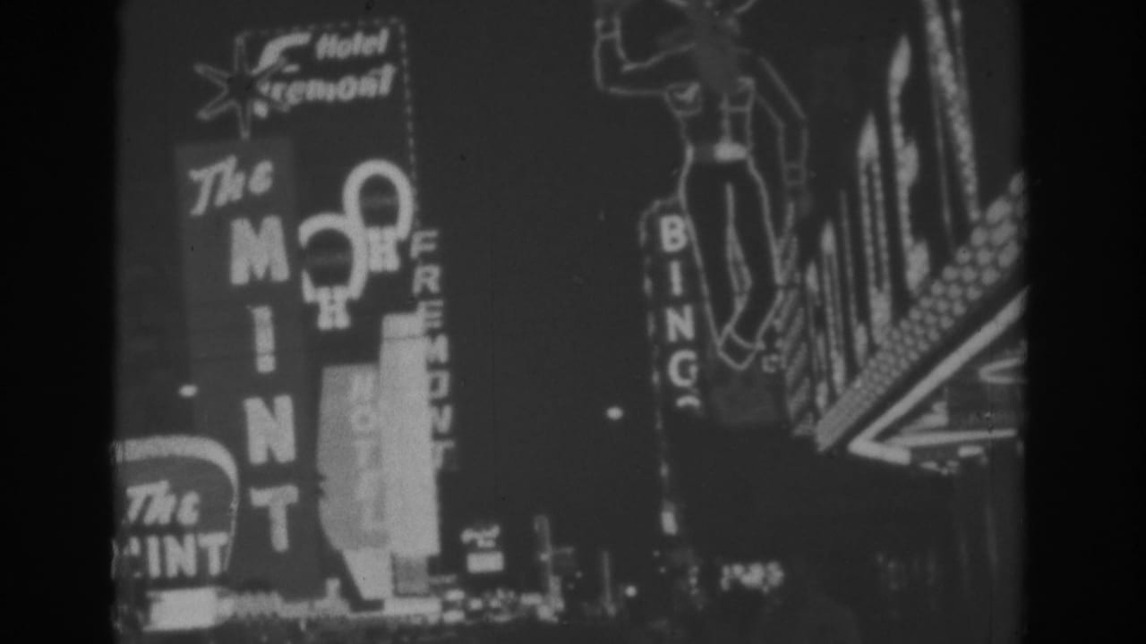 1962 Las Vegas home-movie frame with glowing casino-area signs, including The Mint, Bingo, and Hotel Fremont text.
