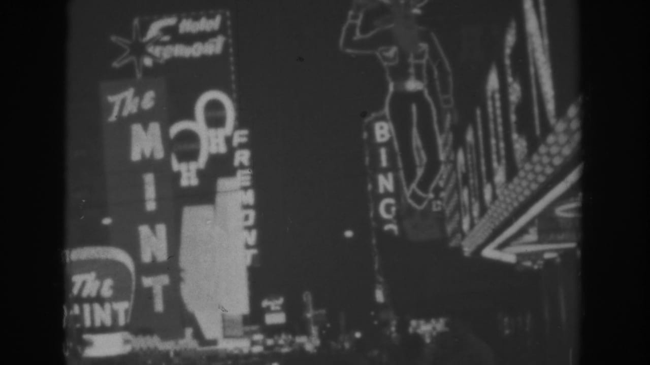 1962 Las Vegas night view with The Mint, Hotel Fremont, Bingo, and nearby casino signage recorded on 8mm film.
