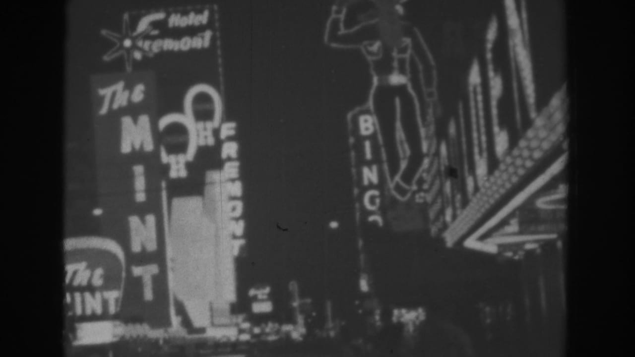 Similar neon casino-sign view with The Mint, Hotel Fremont, and Bingo signs at night.