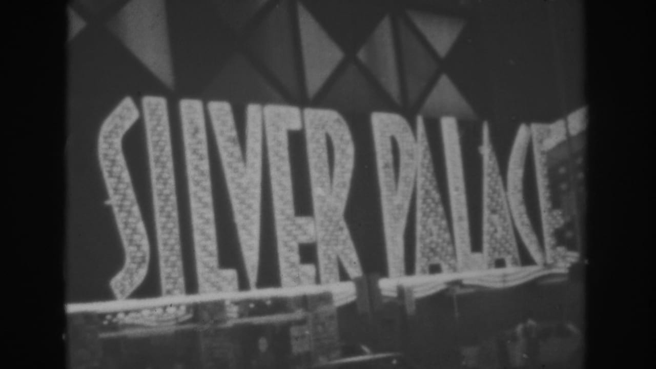 1962 Las Vegas frame showing the Silver Palace marquee below surrounding neon casino and hotel signs.