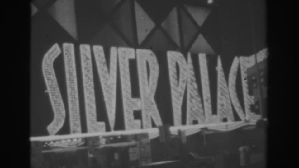1962 Las Vegas home-movie frame showing the SILVER PALACE sign lit against a dark facade.