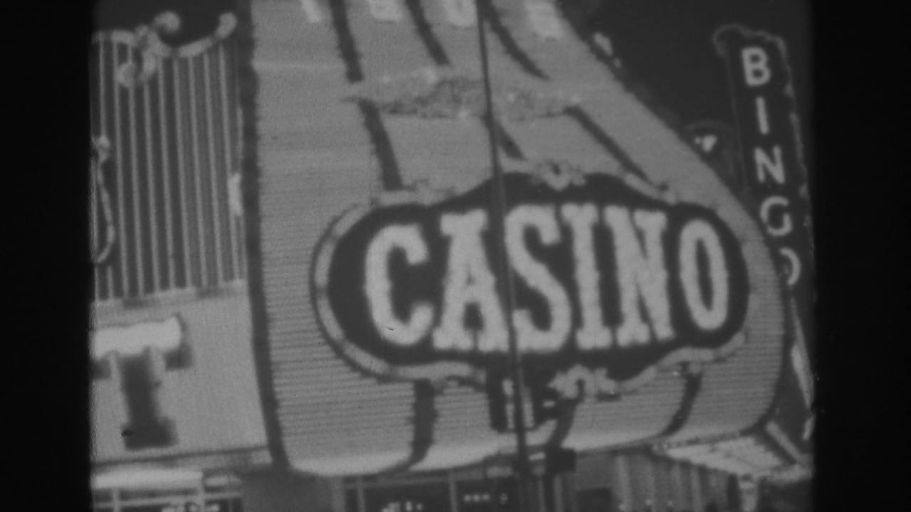 Black-and-white 1962 Las Vegas home-movie frame showing the Gold Nugget casino sign with CASINO lettering and partial BINGO text.