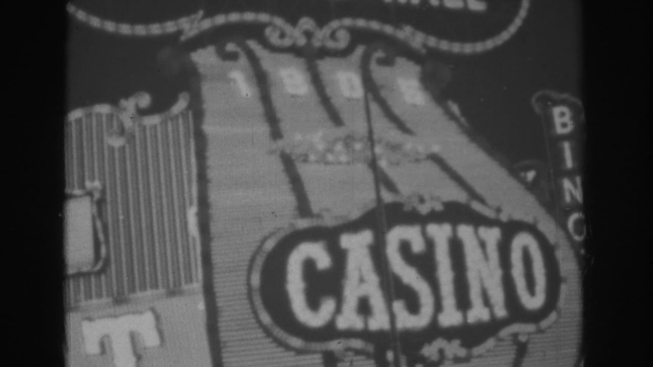 Black-and-white 1962 Las Vegas frame centered on the Gold Nugget sign, with CASINO lettering and ornate illuminated trim.