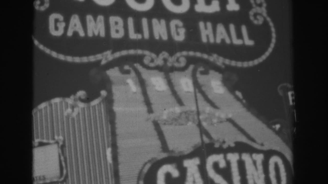Black-and-white 1962 Las Vegas home-movie frame showing the Gold Nugget Gambling Hall sign and partial CASINO lettering.