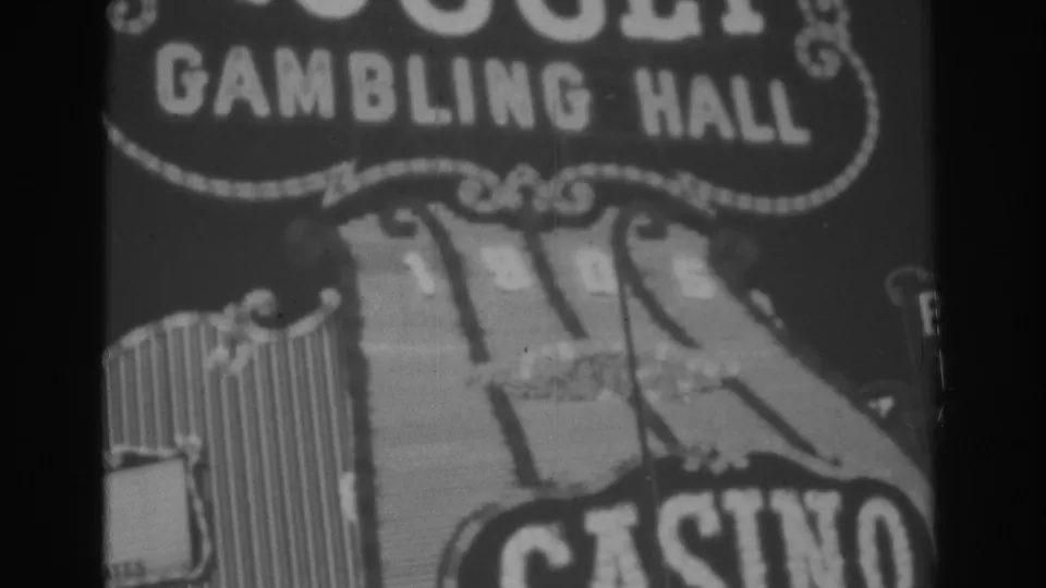 Black-and-white 1962 Las Vegas home-movie frame showing the Gold Nugget Gambling Hall sign and partial CASINO lettering.