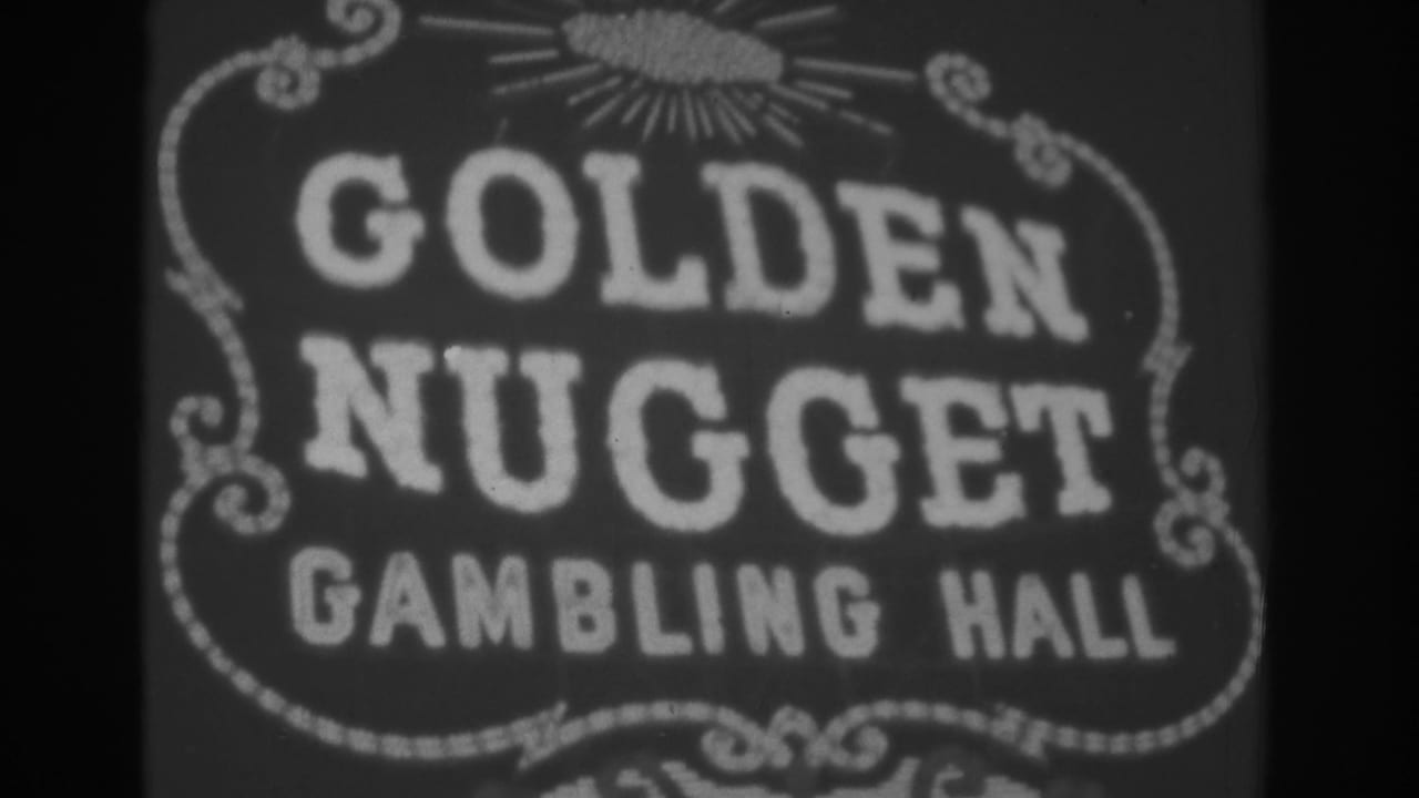 Golden Nugget Gambling Hall sign with sunburst and scrollwork.