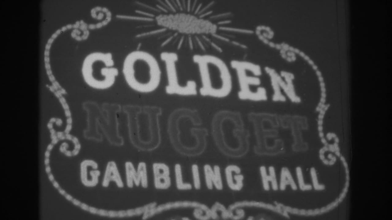 1962 Las Vegas 8mm frame showing the upper Golden Nugget Gambling Hall sign with decorative scrollwork and glowing text.