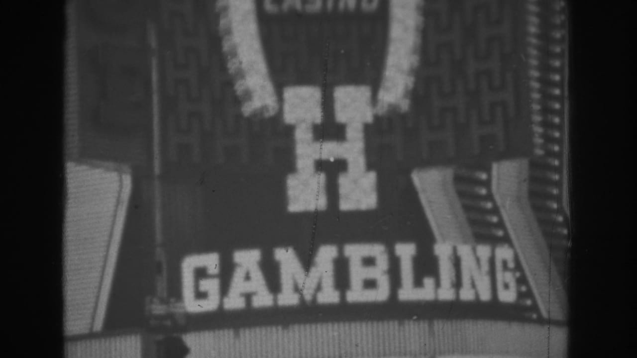 1962 Las Vegas frame showing the lower Golden Nugget sign area, including a large H and partial gambling text.