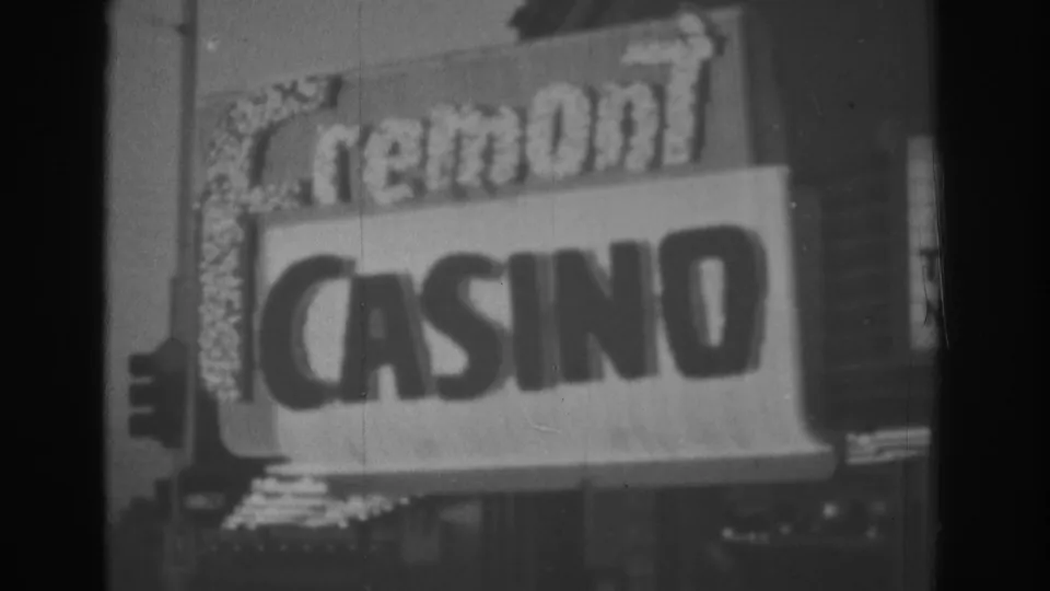Visitor-shot 1962 Las Vegas frame showing the Fremont Casino sign and illuminated border details at night.