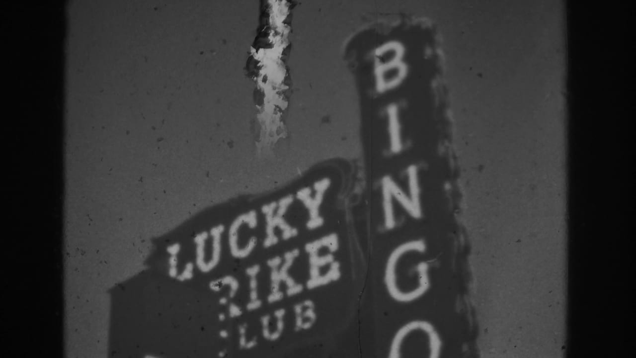 Lucky Rike Club sign beside a vertical BINGO sign at night.