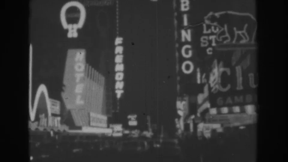 1962 Las Vegas night frame with Hotel Fremont, Bingo, The Mint edge signage, and a bear-logo neon sign in view.