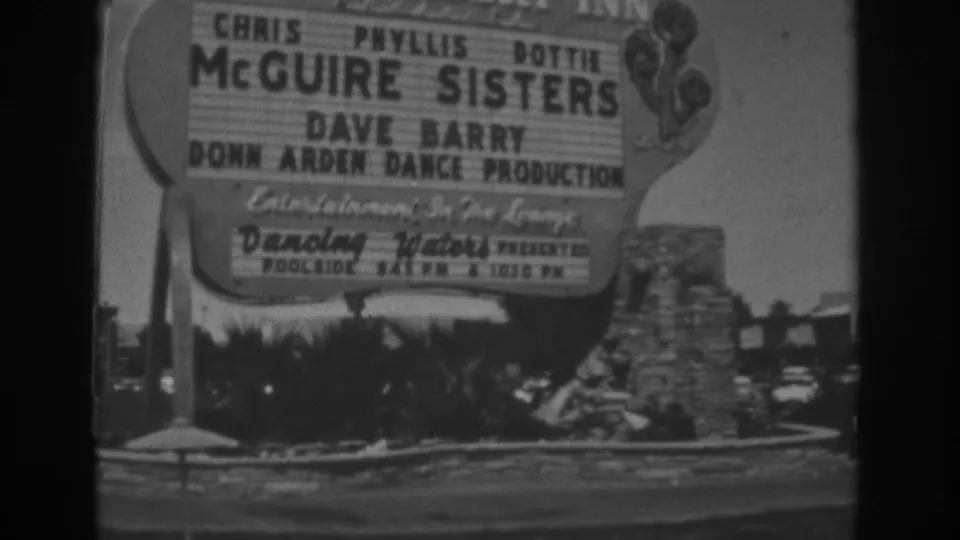 Close 1962 Las Vegas home-movie view of the Stardust roadside marquee, including McGuire Sisters and Donn Arden Dance Production text.