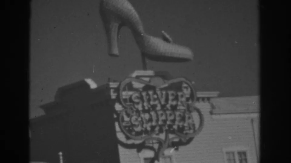 1962 Las Vegas 8mm frame showing the Silver Slipper sign and high-heeled shoe from a slightly shifted visitor-shot angle.