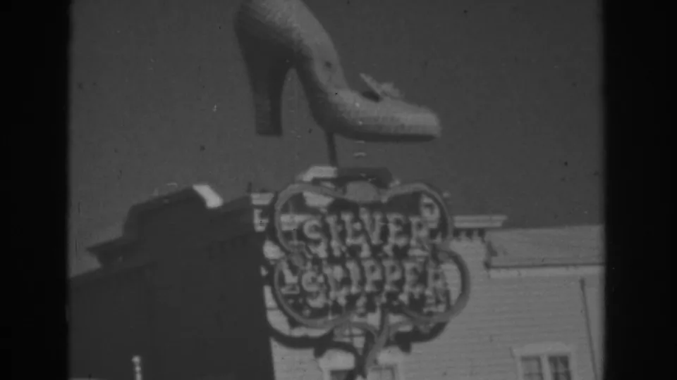 1962 Las Vegas home-movie frame showing a high-heel shoe sign above visible Silver Slipper lettering.