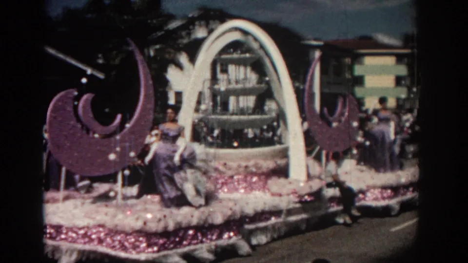 End of the 8mm Pasadena parade shot, with the decorated float close to camera and women in gowns visible on the moving platform.