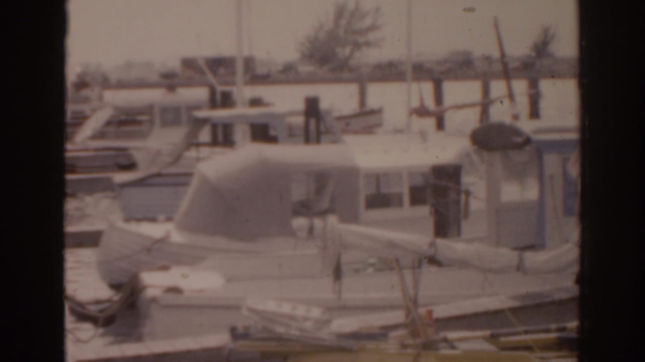 Close view of moored boats and dock pilings in a marina.