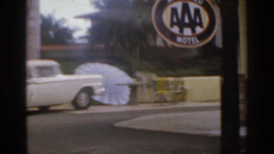 AAA Motel sign visible above a white car and roadside display in 1963 Florida home-movie footage.