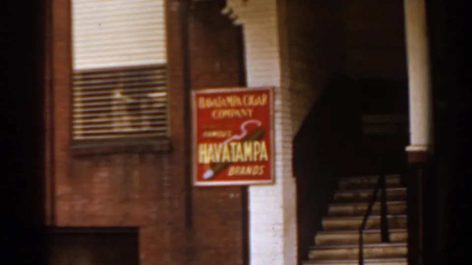 A 1963 Florida street detail shows a brick building, window blinds, stairway, and Havatampa Cigar Company sign.