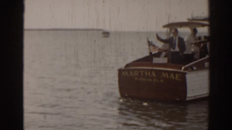 Wooden cruiser MARTHA MAE from Ruskin, Florida appears on the water with passengers and a U.S. flag in 1963 home-movie footage.