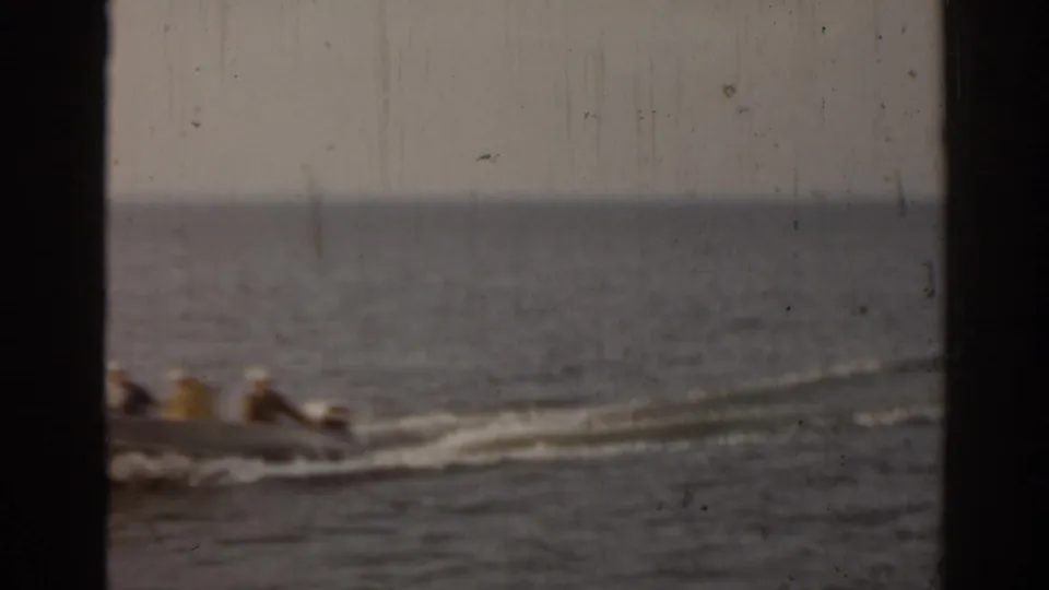 Several passengers ride in a small boat on a Florida waterway in this soft 1963 home-movie frame.