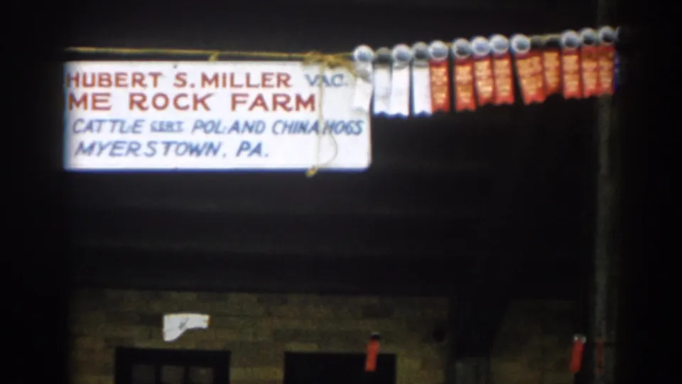 The final frame partly crops the Lime Rock Farm sign while showing a longer row of prize ribbons on the right side.
