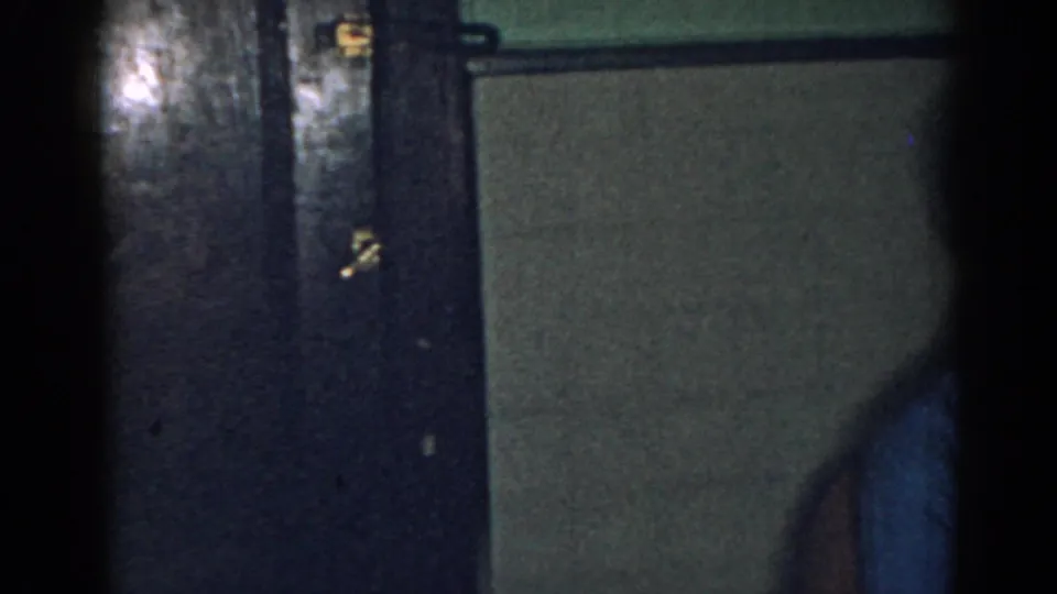 Dim New Jersey home interior with dark doors and a partial adult figure at the frame edge.