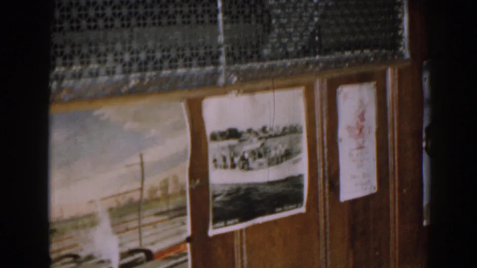 A close view of a home display shows a rail-themed painting, photos, and paper drawings on wood paneling.