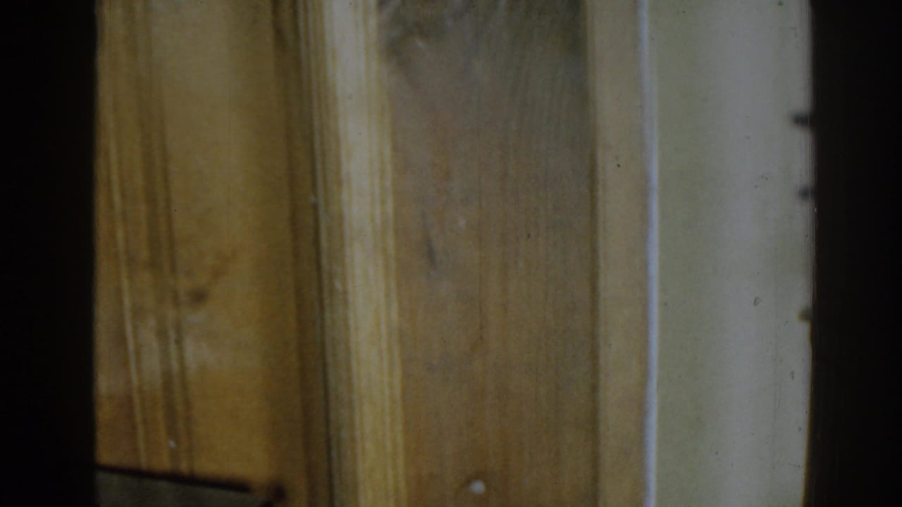 Close view of wood paneling and trim with a dark edge at the left.