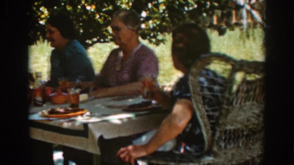 The final frame shows women seated at a 1939 Auburn picnic table, partly shaded by trees, with wicker seating and tableware visible.