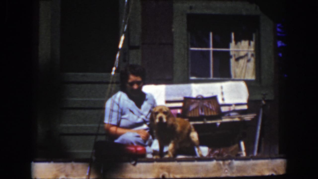 The 1939 Lake Tahoe frame shows the woman seated beside the golden dog, with a porch window and curtains behind them.