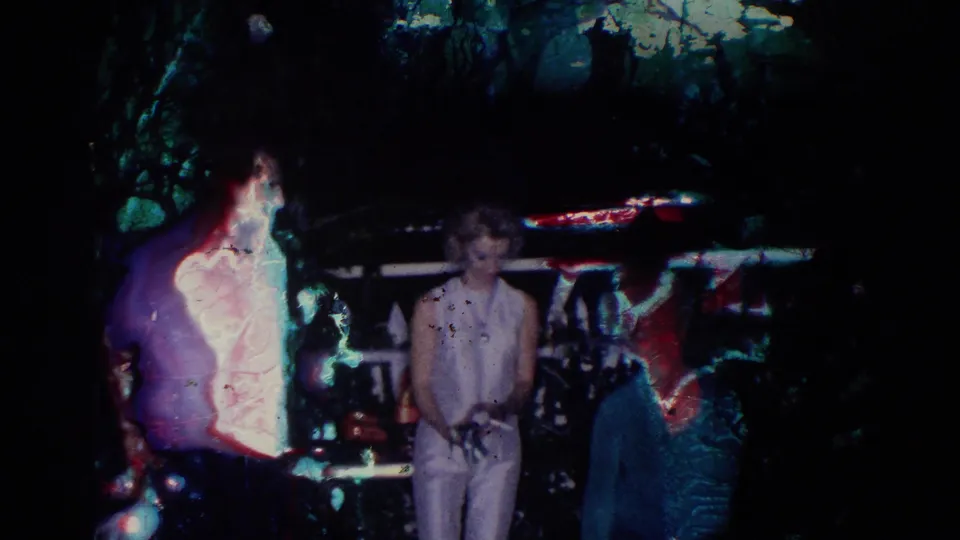 A nighttime 1966 El Monte frame shows adults near a railing, partly obscured by flare or film damage.
